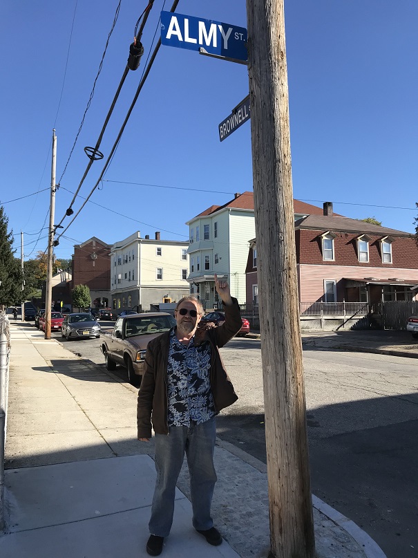 picture of me pointing
to a sign that says Almy Street